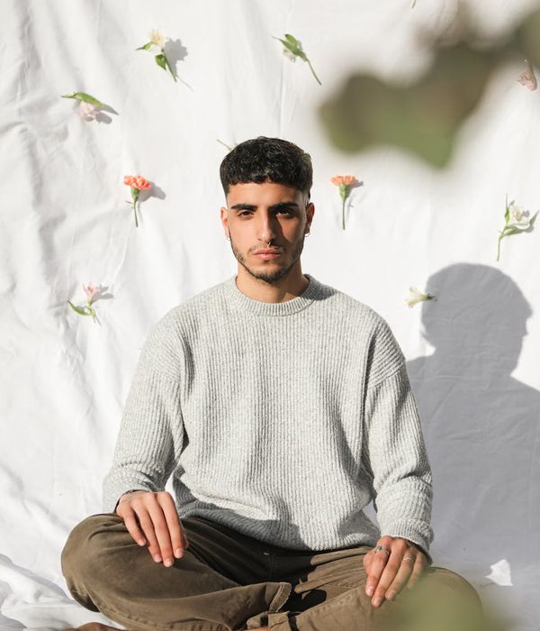 Person meditating peacefully with a serene background.